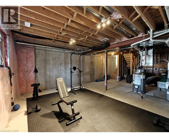 A gym with a wooden ceiling and a variety of exercise equipment.
