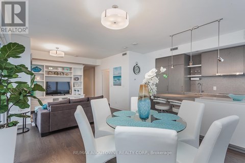 A modern living room with a dining table set up with white chairs.