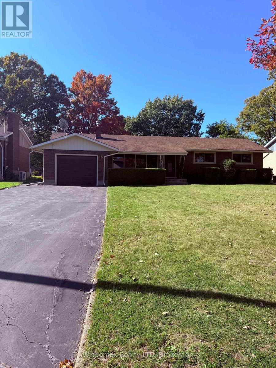 A house with a brown roof and a garage door is surrounded by a grassy lawn and trees.