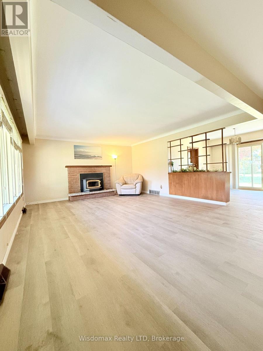 A spacious living room with a fireplace and a couch.
