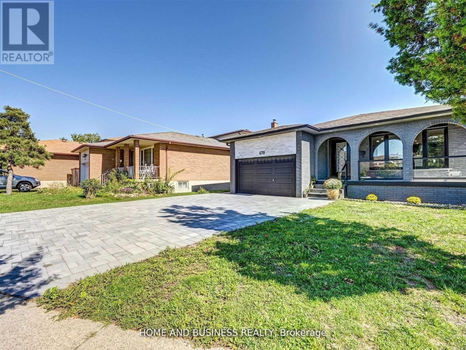 A house with a garage and a driveway is for sale.