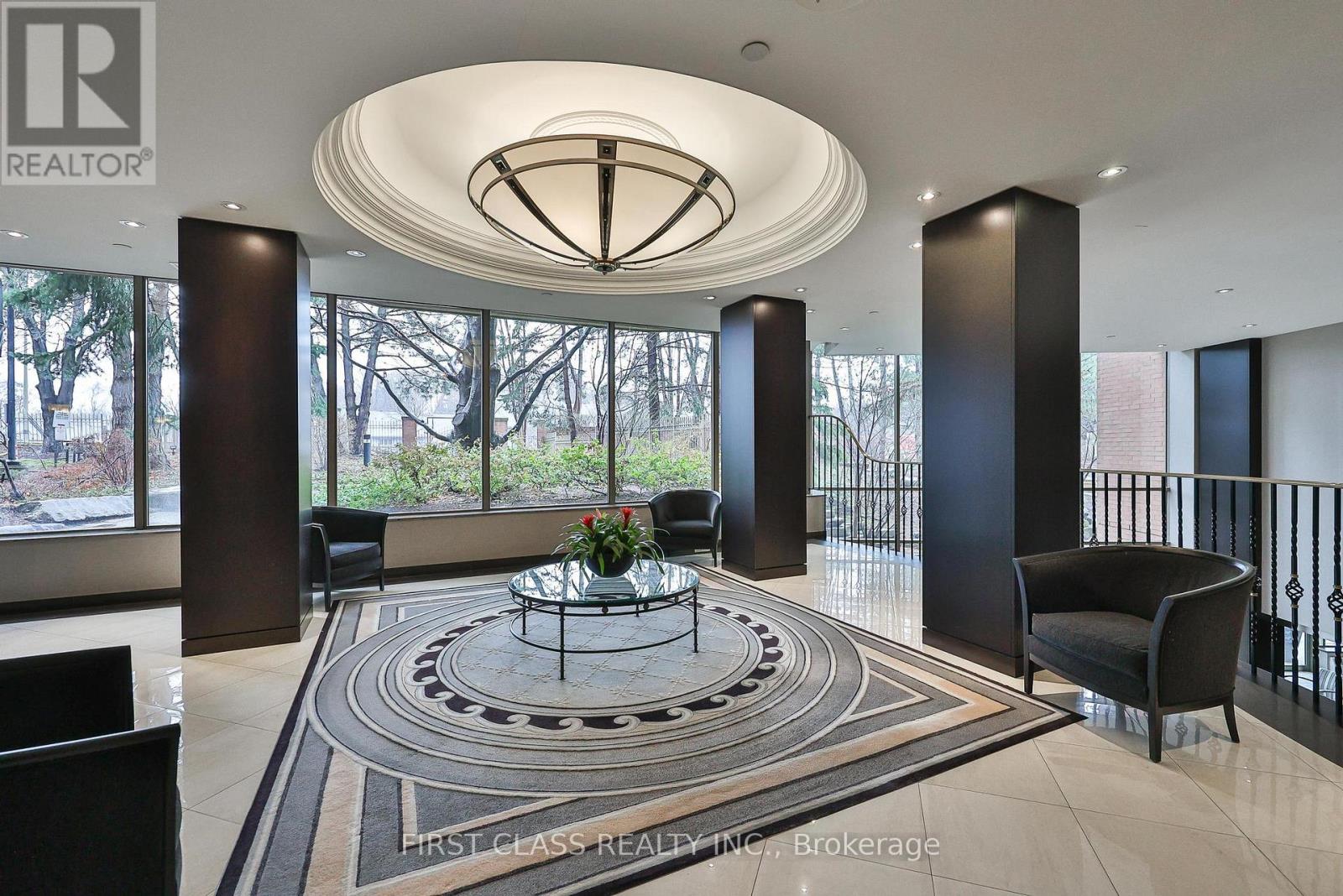 A large, modern living room with a circular coffee table in the center.