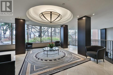 A large, modern living room with a circular coffee table in the center.