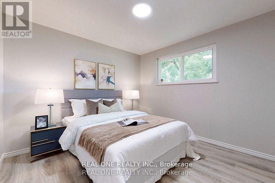 A bedroom with a bed, nightstand, and lamp.