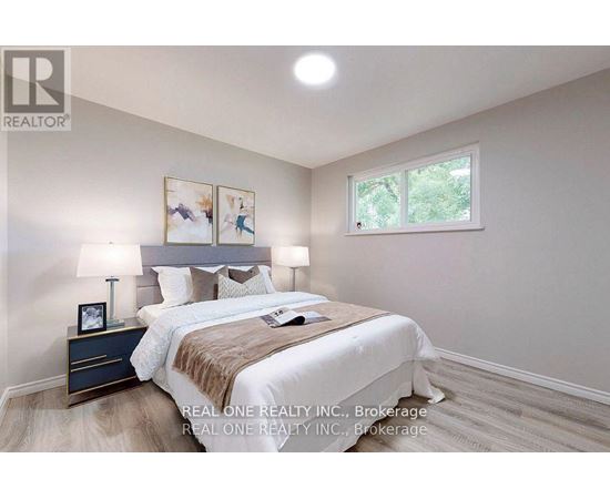 A bedroom with a bed, nightstand, and lamp.