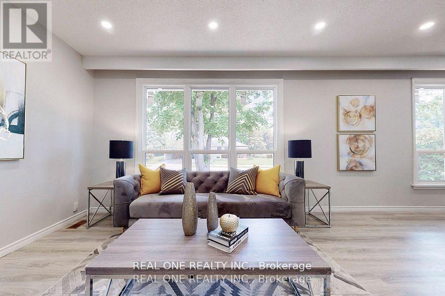 A living room with a grey couch and a coffee table in front of it.