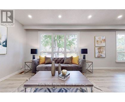 A living room with a grey couch and a coffee table in front of it.