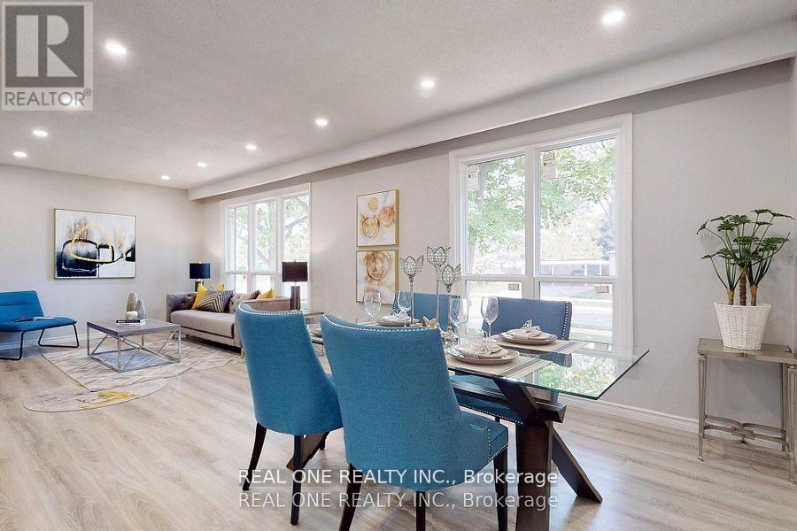 A dining room with a glass table and blue chairs.