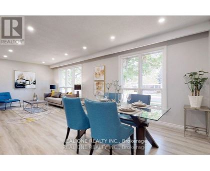 A dining room with a glass table and blue chairs.