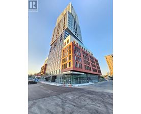 A tall building with a glass facade is under construction.
