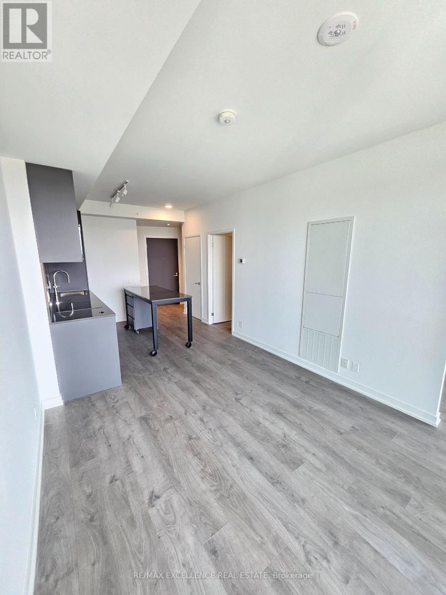 A spacious room with a grey floor and white walls.