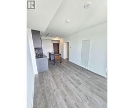 A spacious room with a grey floor and white walls.