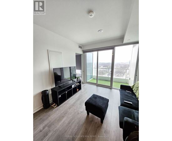 A living room with a television and a glass door.