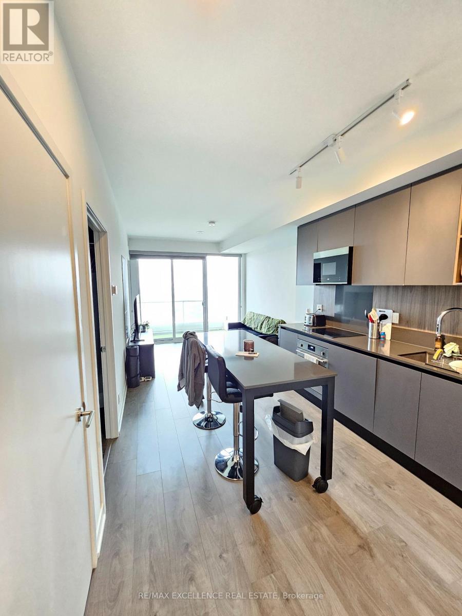 A modern kitchen with a dining table and chairs.
