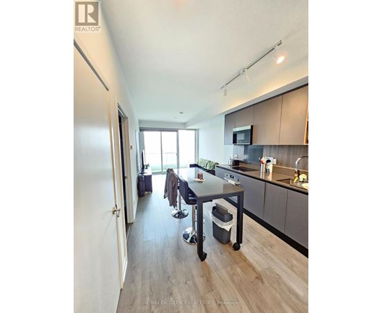 A modern kitchen with a dining table and chairs.