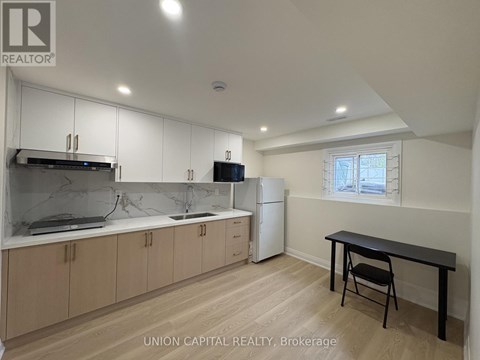 A kitchen with wooden cabinets and a black table.