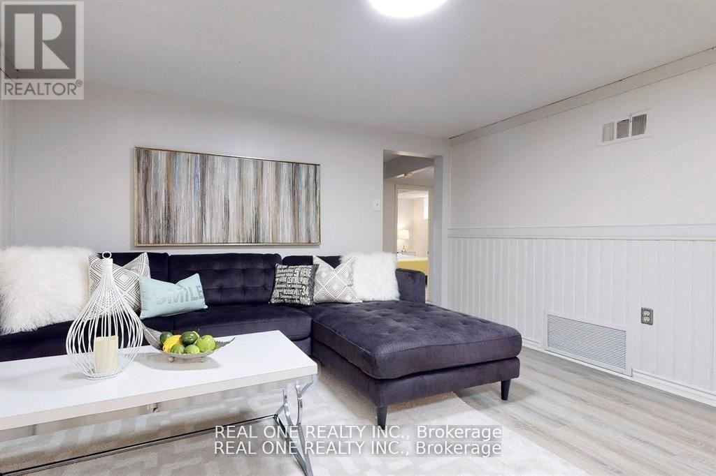A living room with a grey couch and a white coffee table.