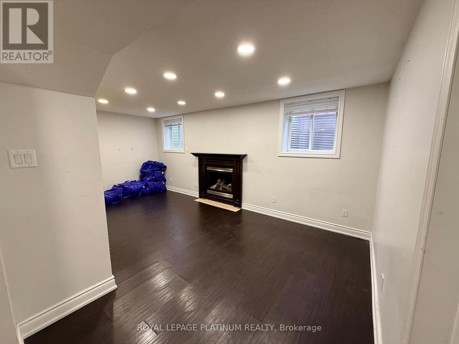 A room with a fireplace and a window.