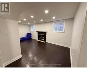 A room with a fireplace and a window.