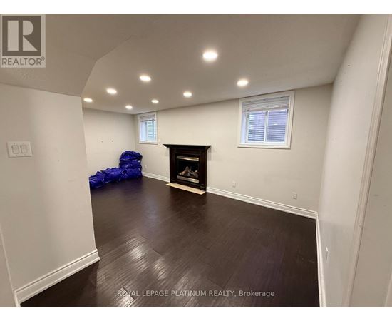 A room with a fireplace and a window.
