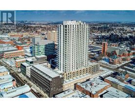 A cityscape with a large building in the center and smaller buildings surrounding it.