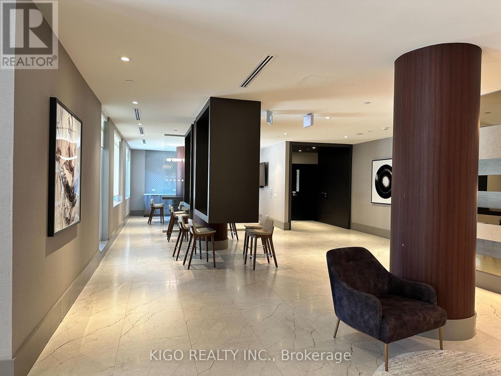 A modern living room with a dark brown chair and a marble floor.