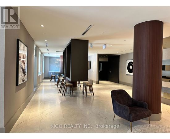 A modern living room with a dark brown chair and a marble floor.