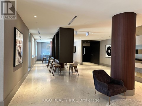 A modern living room with a dark brown chair and a marble floor.