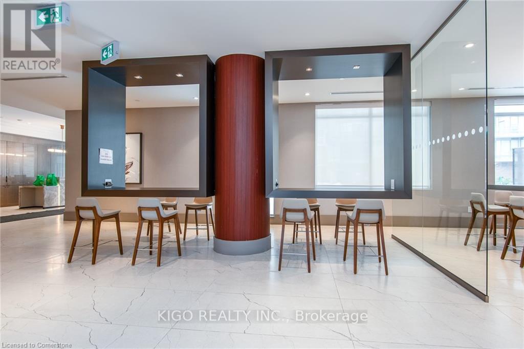 A modern office space with a glass wall and wooden chairs.
