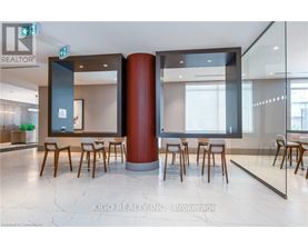 A modern office space with a glass wall and wooden chairs.