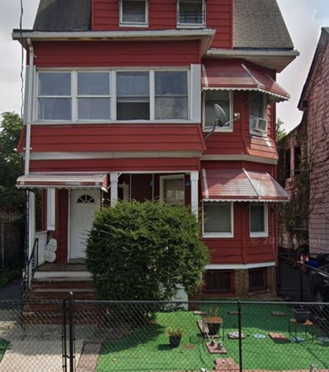 A red house with a white door and windows.