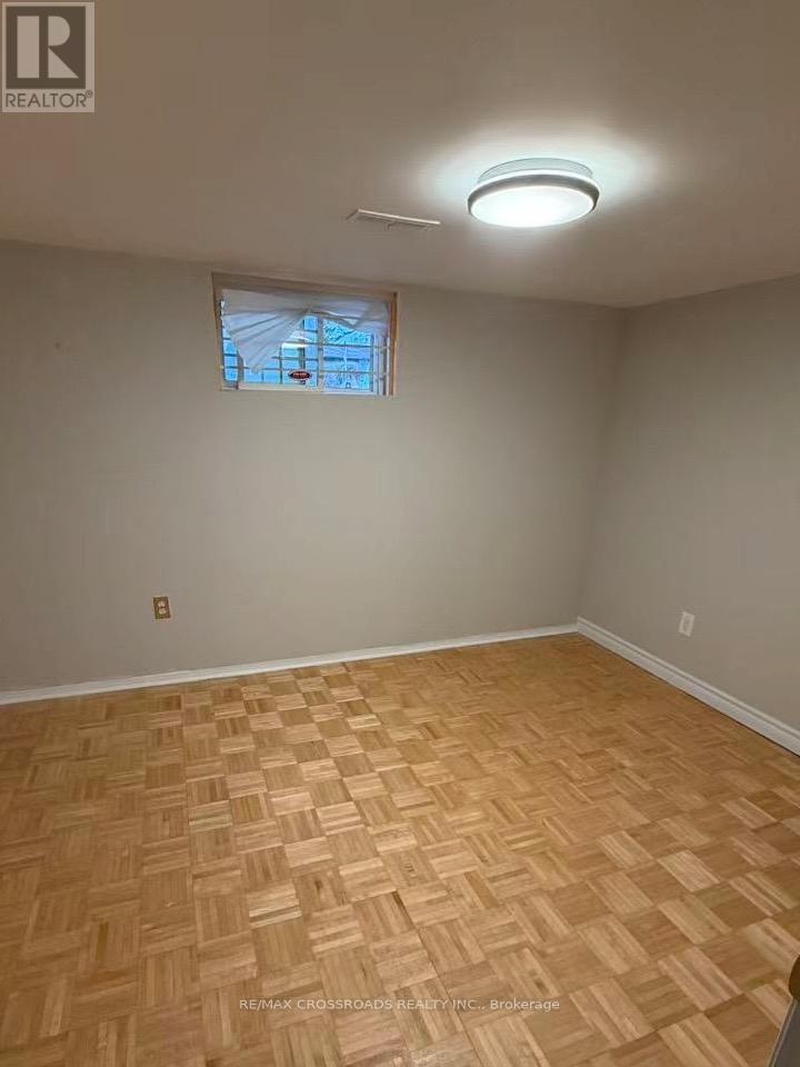A room with a wooden floor and a window.