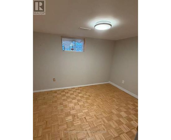 A room with a wooden floor and a window.