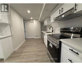 A kitchen with white cabinets and a stainless steel oven.
