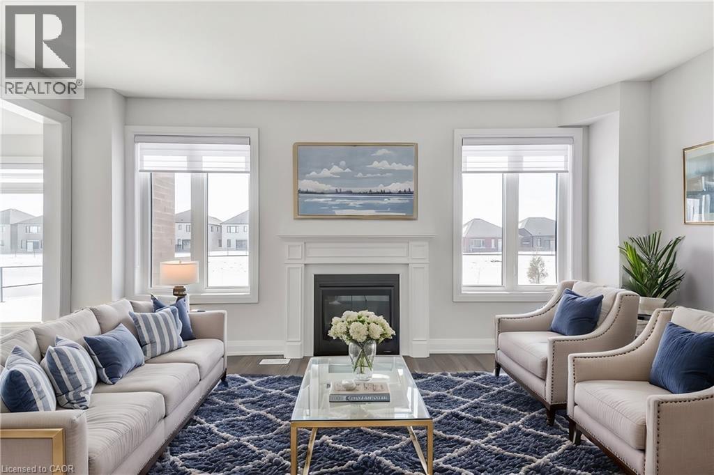 A living room with a fireplace and a painting on the wall.