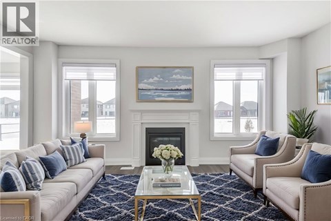 A living room with a fireplace and a painting on the wall.