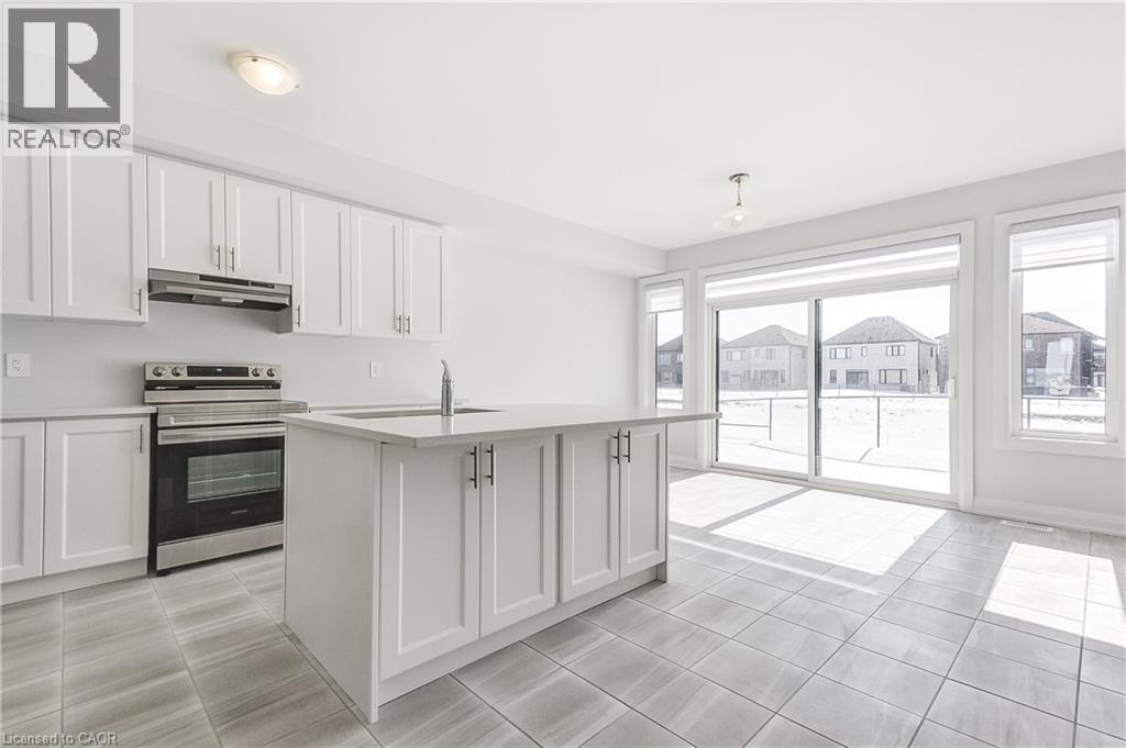 A modern kitchen with white cabinets and a large island.