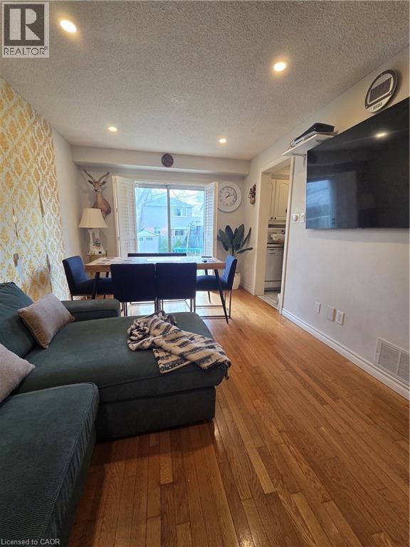 A living room with a green couch and a television.