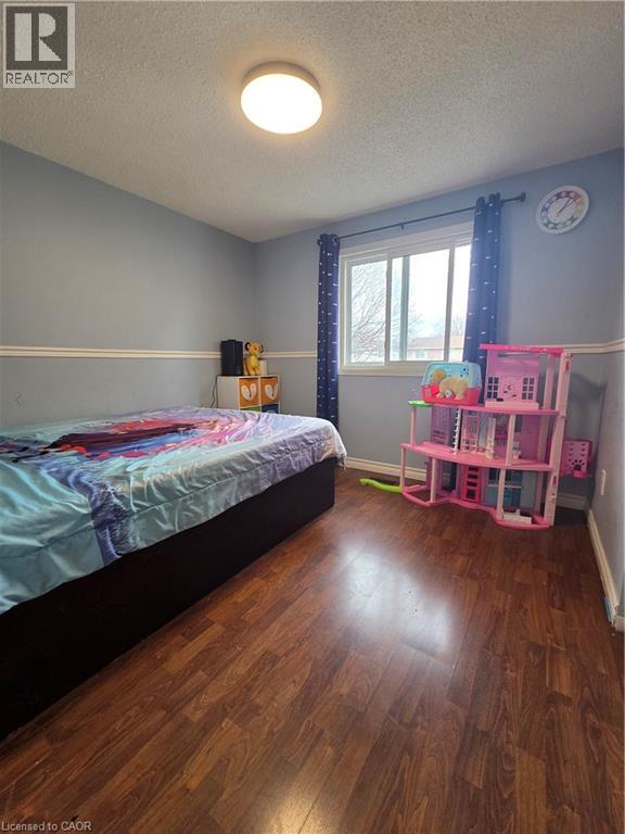 A bedroom with a bed and a pink shelf.