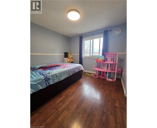 A bedroom with a bed and a pink shelf.