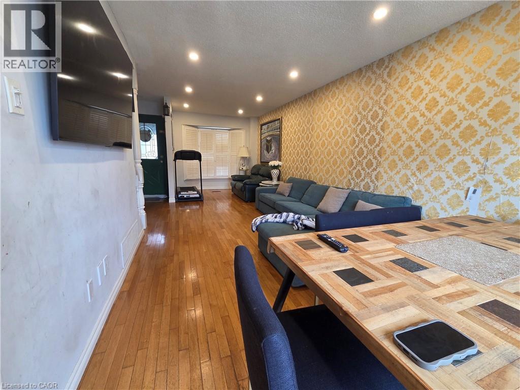 A living room with a wooden table and a blue couch.