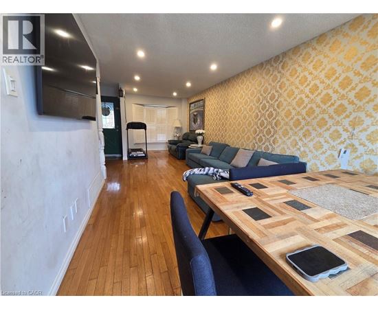 A living room with a wooden table and a blue couch.