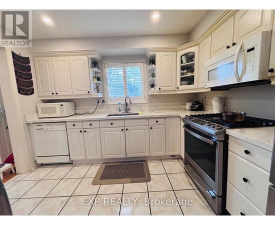 A kitchen with white cabinets and appliances.