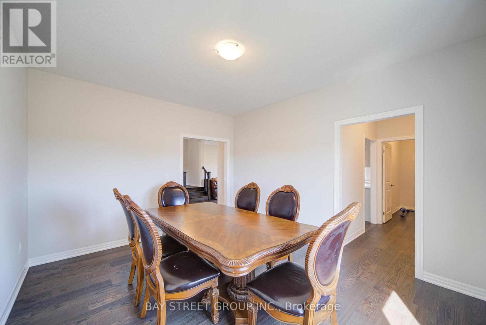 A dining room with a wooden table and chairs.