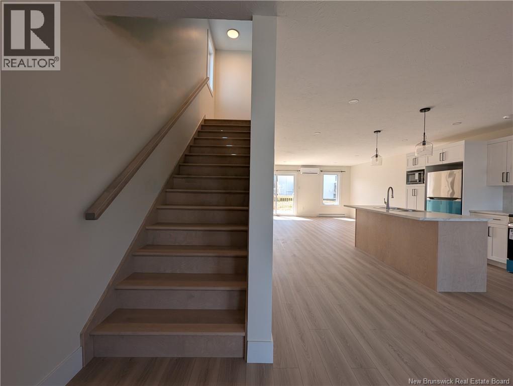 A staircase with wooden steps and a white wall.
