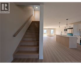 A staircase with wooden steps and a white wall.
