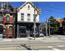 A street corner with a traffic light and a building with a sign that says "Piazza's".