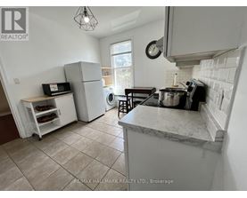 A kitchen with a marble countertop and a tile floor.