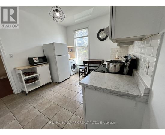 A kitchen with a marble countertop and a tile floor.