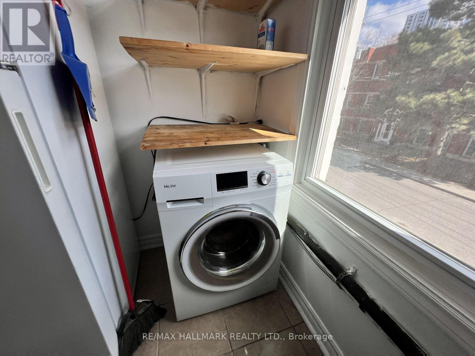 A small laundry room with a washer and dryer.